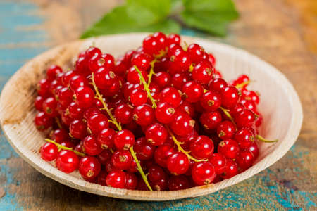 Fresh ripe red currant berries on the table, healthy foodの写真素材