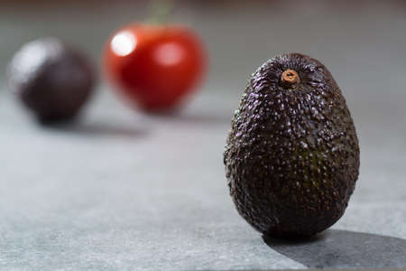 Ripe avocado close up on gray concrete background, diet and healthy food concept, copy spaceの写真素材