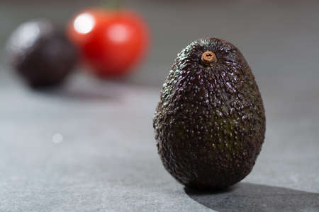 Ripe avocado close up on gray concrete background, diet and healthy food concept, copy spaceの写真素材