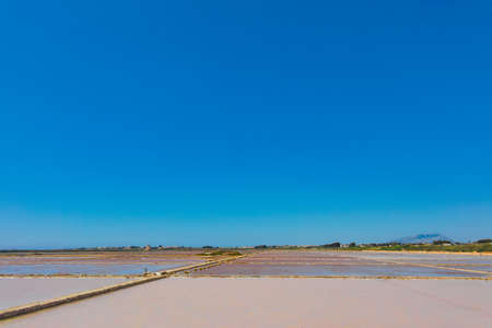 Sea saltworks, salt fields are seen in suburbs of Marsala, Sicily, Italy.の写真素材