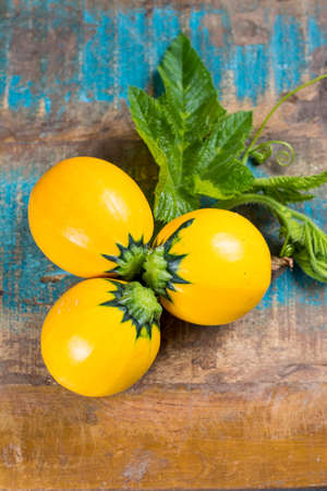Round yellow courgette or zucchini, on wooden background, close up, healthy foodの写真素材