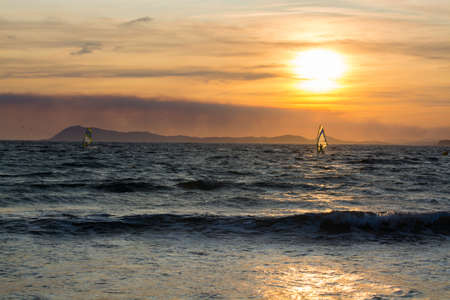 Sunset over the sea or ocean and extreme freestyle sport windsurfing, France, Giensの写真素材