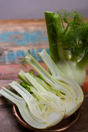 Fresh raw organic Florence fennel bulbs, close up on wooden table