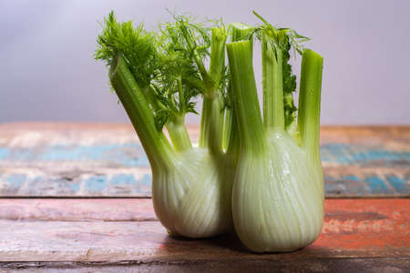 Fresh raw organic Florence fennel bulbs, close up on wooden tableの写真素材