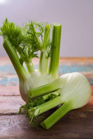 Fresh raw organic Florence fennel bulbs, close up on wooden tableの写真素材