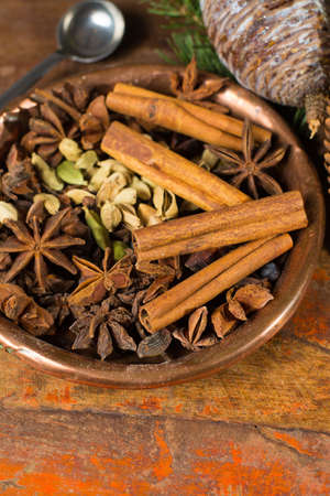 Collection of spices for winter and Christmas days, used for baking and mulled wine on wooden tableの写真素材