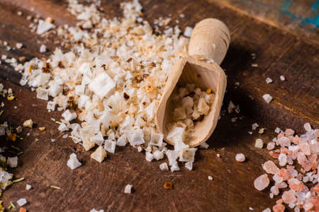 Variety of sea salt, white salt flakes on wooden tableの写真素材