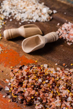 Variety of sea salt, pink Himalayan salt, colorful salt with dried chili pepper, herbs and spices close upの写真素材