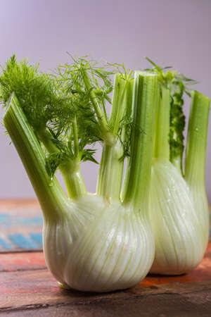 Fresh raw organic Florence fennel bulbs, close up on wooden tableの写真素材