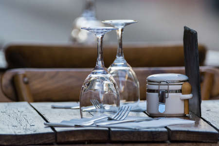 Empty wine glasses on the table served for lunch, dinner in cafe, restaurant outside or on terrase, vacation timeの写真素材