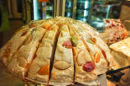 Fresh colorful dessert - traditional nougat with nuts and fruits in small shop in Franceの写真素材