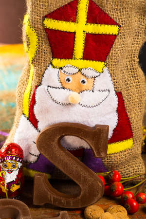 Traditional Dutch Saint Nicolas celebration with presents for children in December, Saint Nicolas  gift bag and chocolate letters close upの写真素材