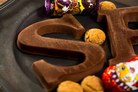 Traditional Dutch Saint Nicolas celebration with presents for children in December, Saint Nicolas chocolate letters and spicy cookies close upの写真素材