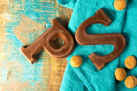 Traditional Dutch Saint Nicolas celebration with presents for children in December, Saint Nicolas chocolate letters and spicy cookies close upの写真素材