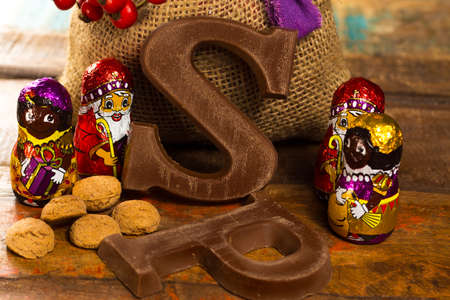 Traditional Dutch Saint Nicolas celebration with presents for children in December, Saint Nicolas  gift bag and chocolate letters close upの写真素材