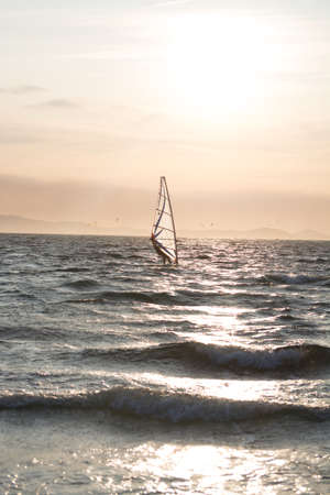 Sunset over the sea or ocean and extreme freestyle sport windsurfing, France, Giensの写真素材