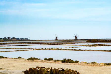 Sea saltworks, salt wind mills are seen in suburbs of Marsala, Sicily, Italy.