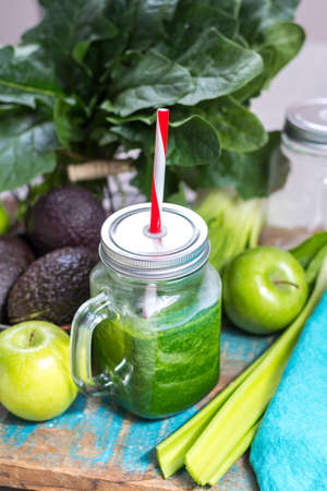 Fresh green vegetables and fruits, ingredients for dietary healthy detox green smoothie, glass jar with green smoothieの写真素材