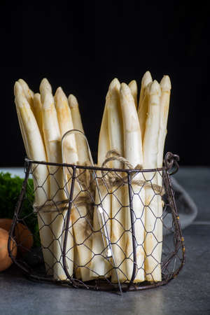 Spring season, new harvest of Dutch, German white asparagus, bunch of raw white asparagusの写真素材