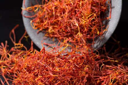Macro collection, expensive real dried saffron spice close up on black background