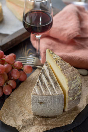 Tasting of ancient french demi soft cheese Tomme from French Alps, made from cow, goat or sheep skim milk, low fat french cheese close upの写真素材