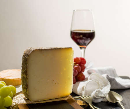 Tasting of ancient french demi soft cheese Tomme from French Alps, made from cow, goat or sheep skim milk, low fat french cheese close upの写真素材