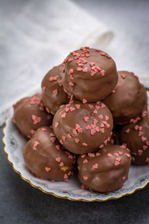 Valentine's Day concept, chocolate profiteroles with pink hearts, stuffed cakes,  special romantic event, sweet desertの写真素材