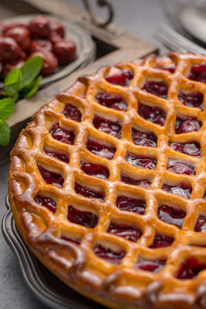 Homemade open sour cherry pie, delicious sweet dessert served on gray tableの写真素材