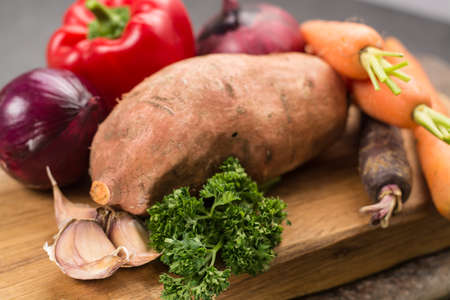 Tasty vegetarian food, colorful ingredients for sweet potato soup, raw and uncooked.の写真素材