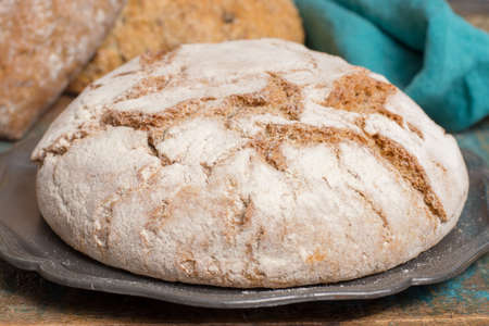 Farmers homemade organic wheat, barley and rye bread in assortment on table