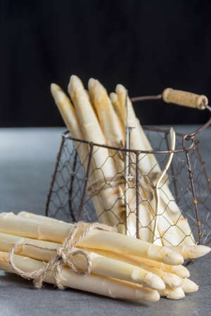 Spring season, new harvest of Dutch, German white asparagus, bunch of raw white asparagusの写真素材