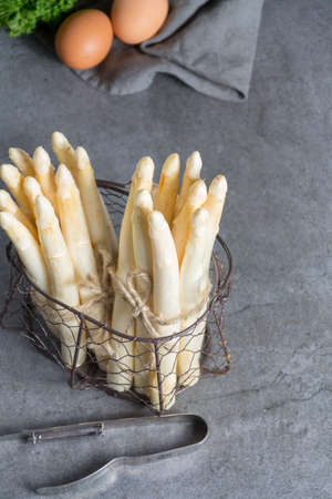 Spring season, new harvest of Dutch, German white asparagus, bunch of raw white asparagusの写真素材