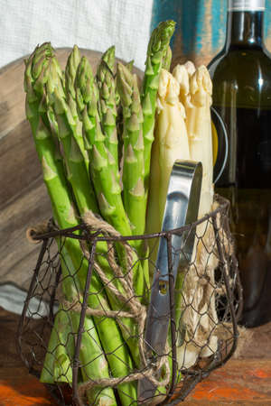 Raw uncooked high quality white and green asparagus, ready to cook for dinner, seasonal dishの写真素材