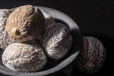 Macro collection, dried muscat nutmeg close up on black backgroundの写真素材