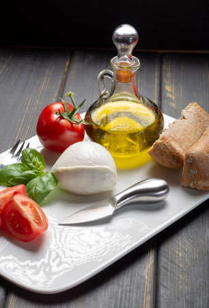 Traditional italian food - white ball mozzarella buffalo Italian soft cheese with cheese knife,...