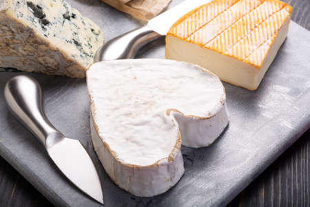 French cheeses plate in assortment,  Neufchatel heart shaped aged white cow cheese from Normandyの写真素材