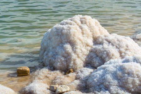 Stones with salt, lowest salty lake in world below sea level Dead sea, full of minerals near luxury vacation resort Ein Bokek, perfect place for medical treatments, climatotherapy, thalassotherapy and heliotherapy.の写真素材