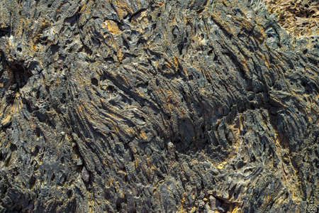 Abstract dark background, natural lava stone texture close upの写真素材