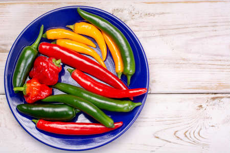Colorful fresh hot Mexican chili peppers in assortment top view copy spaceの写真素材