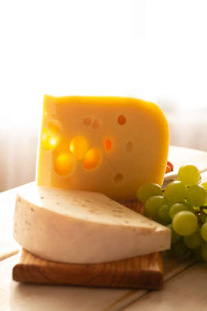 Dutch hard cheese Maasdam or Emmentaler, cheese with holesの写真素材