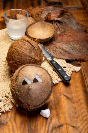 Big tropical palm nut coconut and coconut milk on wooden background close upの写真素材