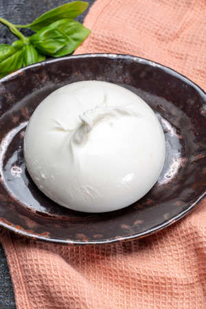 Fresh soft white burrata, ball buttery cheese, made from a mix of mozzarella and ricotta cream, original from Apulia region, Italy, very popular soft cheese in USAの写真素材