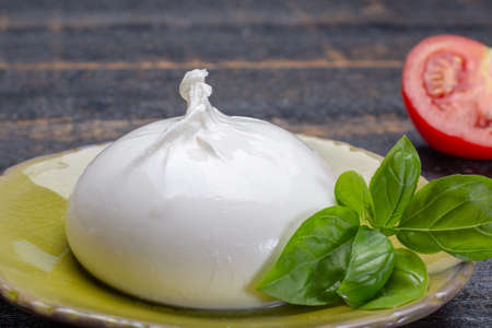 Fresh soft white burrata, ball buttery cheese, made from a mix of mozzarella and ricotta cream,...