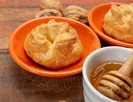 French snack pouches made from puff pastry with fresh soft goat cheese and honingの写真素材