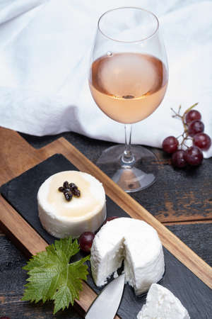 French soft cheeses, variety of different taste goat milk natural cheeses on granite plate close up...