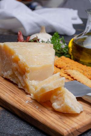 Traditional italian food - 36 months aged in caves Italian parmesan hard cheese from Parmigiano-Reggiano, Italyの写真素材