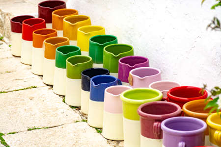Rows with colorful glazed ceramic jars, flower pots, vases for saleの写真素材