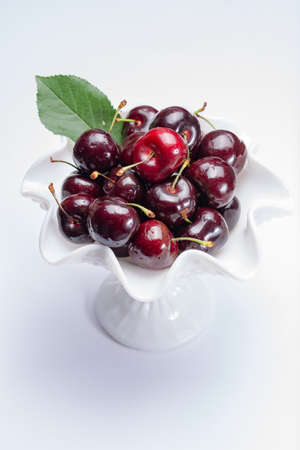 Giant fresh ripe black cherries, new harvest, ready to eat close upの写真素材