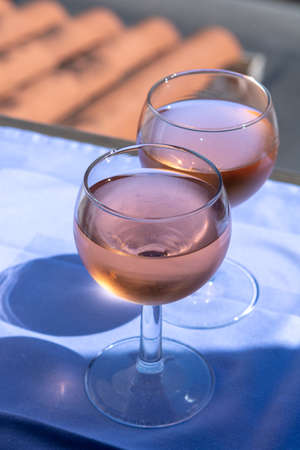 Rose wine of Provence, France, served cold on outdoor terrace in two wine glasses on sunny day
