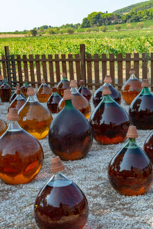 Making of natural sweet dessert muscat liqueur white wine outside in big round glass antique...